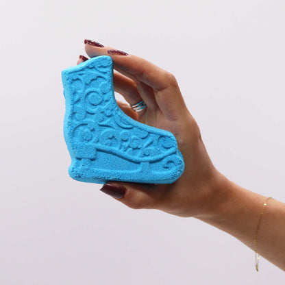 A close-up of the blue ice skate bath bomb from the Christmas Fun Bath Bomb Gift Pack, highlighting its intricate design. This unique bath bomb emits a pleasant Frosted Sugar Plum scent, making it a charming addition to any festive holiday gift.