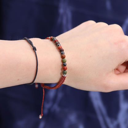 Close-up of the Zodiac Crystal Bracelet from the Zodiac Crystal Candle with Gemstone Bracelet - Aries on a hand. The bracelet is made from powerful gemstones, enhancing its appeal when paired with the Clear Quartz Freshness candle for a thoughtful Christmas Gift Home Fragrance.