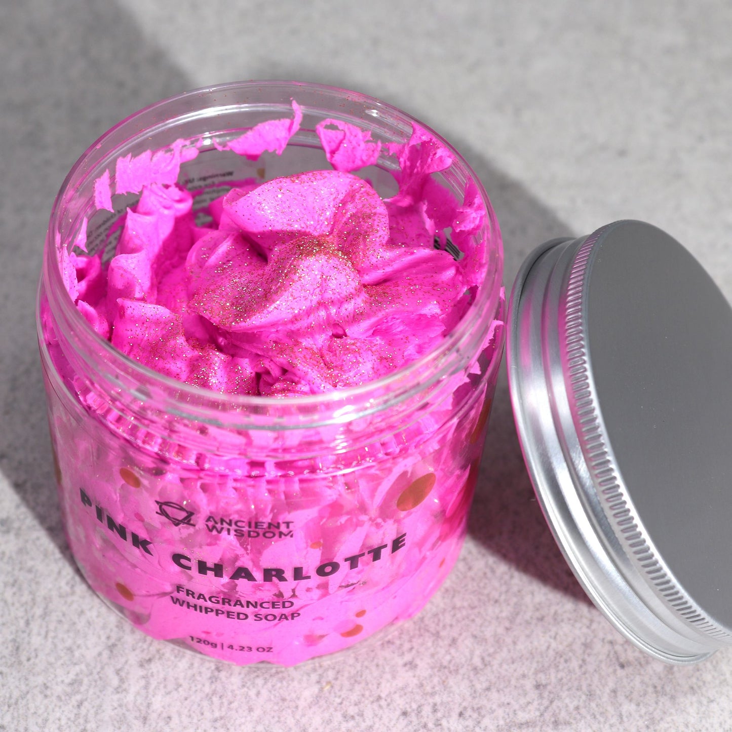 Open jar of Pink Charlotte Whipped Cream Soap 120g revealing its sparkling whipped soap. The enchanting {{scent}} makes this {{product_type}} a lovely Christmas gift home fragrance for those cosy moments.
