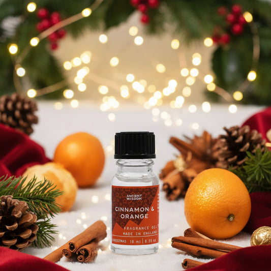 10ml Xmas Cinnamon & Orange Fragrance Oil displayed with festive decorations, perfect as a Christmas gift or stocking filler. This delightful winter spice blend enhances home fragrance, ideal for aromatherapy, creating a cozy atmosphere with the sweet notes of cinnamon orange.