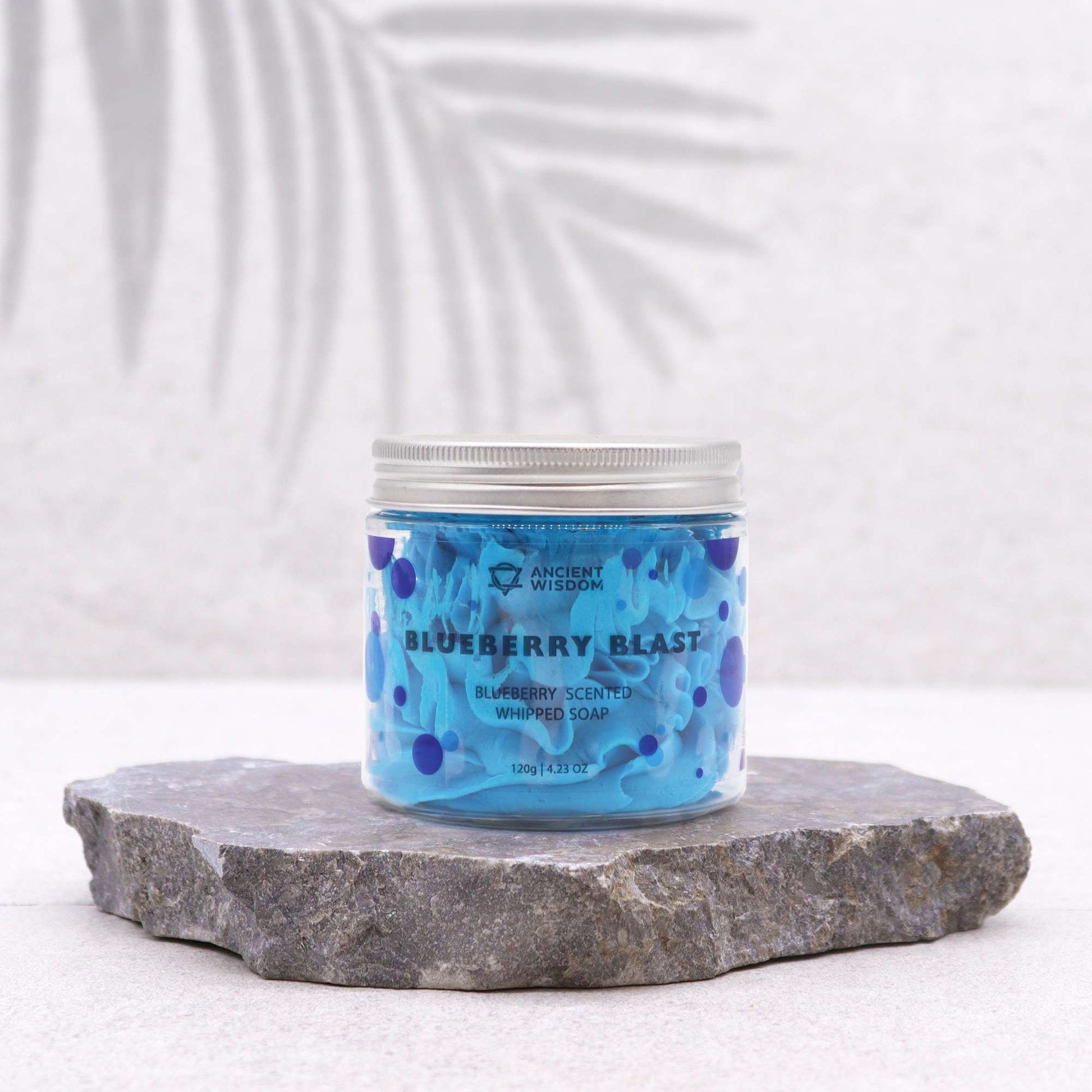 Blueberry Whipped Soap 120G displayed in a jar placed on stone, highlighting its vibrant blue colour, a delightful vegan skin treat and a thoughtful Christmas gift for home fragrance.