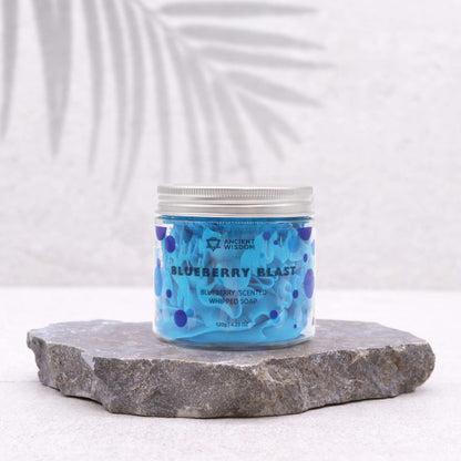 Blueberry Whipped Soap 120G displayed in a jar placed on stone, highlighting its vibrant blue colour, a delightful vegan skin treat and a thoughtful Christmas gift for home fragrance.