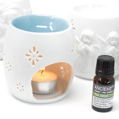 Elegant Cherubs Design Ceramic Oil Burners with a tea light candle and tea tree essential oil. Perfect for creating a serene atmosphere, this beauty is an ideal Christmas gift for home fragrance lovers.
