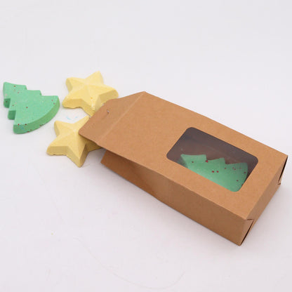 Chocolate brown cardboard box containing two green Christmas tree bath bombs and two yellow star bath bombs, highlighting the charm of the Silent Night Christmas Bath Bomb Gift Pack for a unique Christmas Gift Home Fragrance.