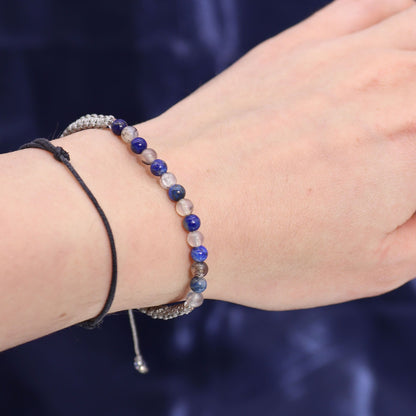 Zodiac Crystal Candle with Gemstone Bracelet - Taurus, highlighting the lapis lazuli bracelet on a wrist, paired with the candle's calming scent of forest emerald and patchouli. A unique Christmas gift for home fragrance enthusiasts.