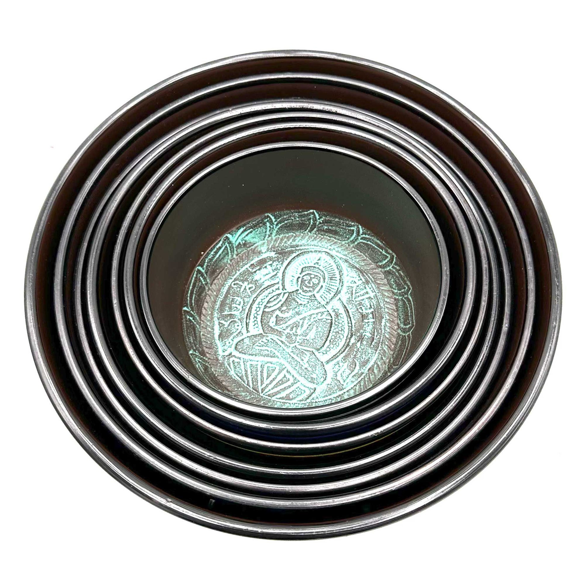 Top view of stacked singing bowls from the Large 7 Chakra Singing Bowls Set, featuring intricate designs perfect for enhancing your home décor. A thoughtful Christmas gift for wellness and fragrance.