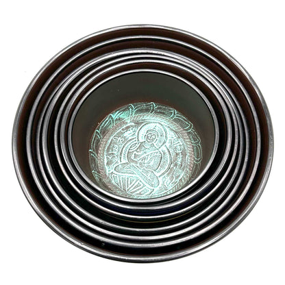 Top view of stacked singing bowls from the Large 7 Chakra Singing Bowls Set, featuring intricate designs perfect for enhancing your home décor. A thoughtful Christmas gift for wellness and fragrance.