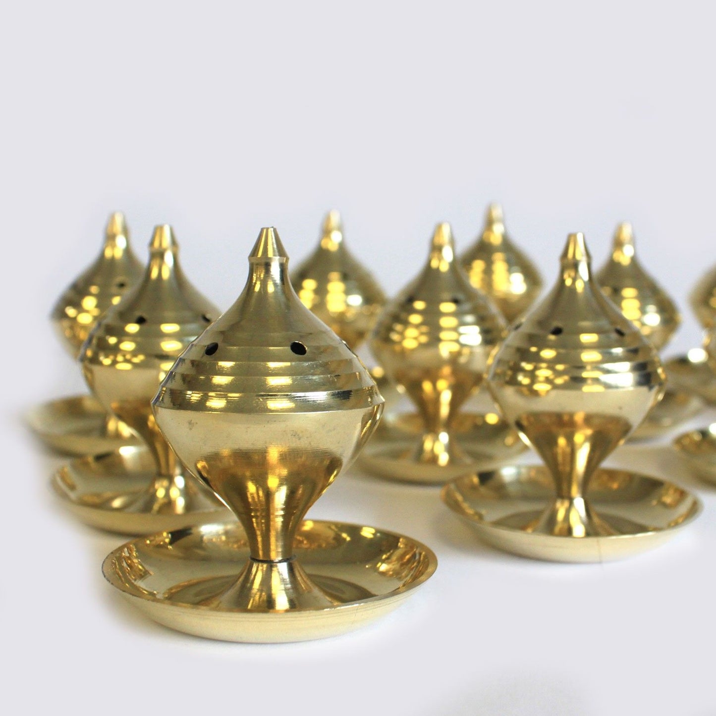 Elegant Medium Brass Incense Burner – Rituals & Meditation displayed among multiple burners, showcasing their unique design and polished brass finish. A charming option for Christmas Gift Home Fragrance.
