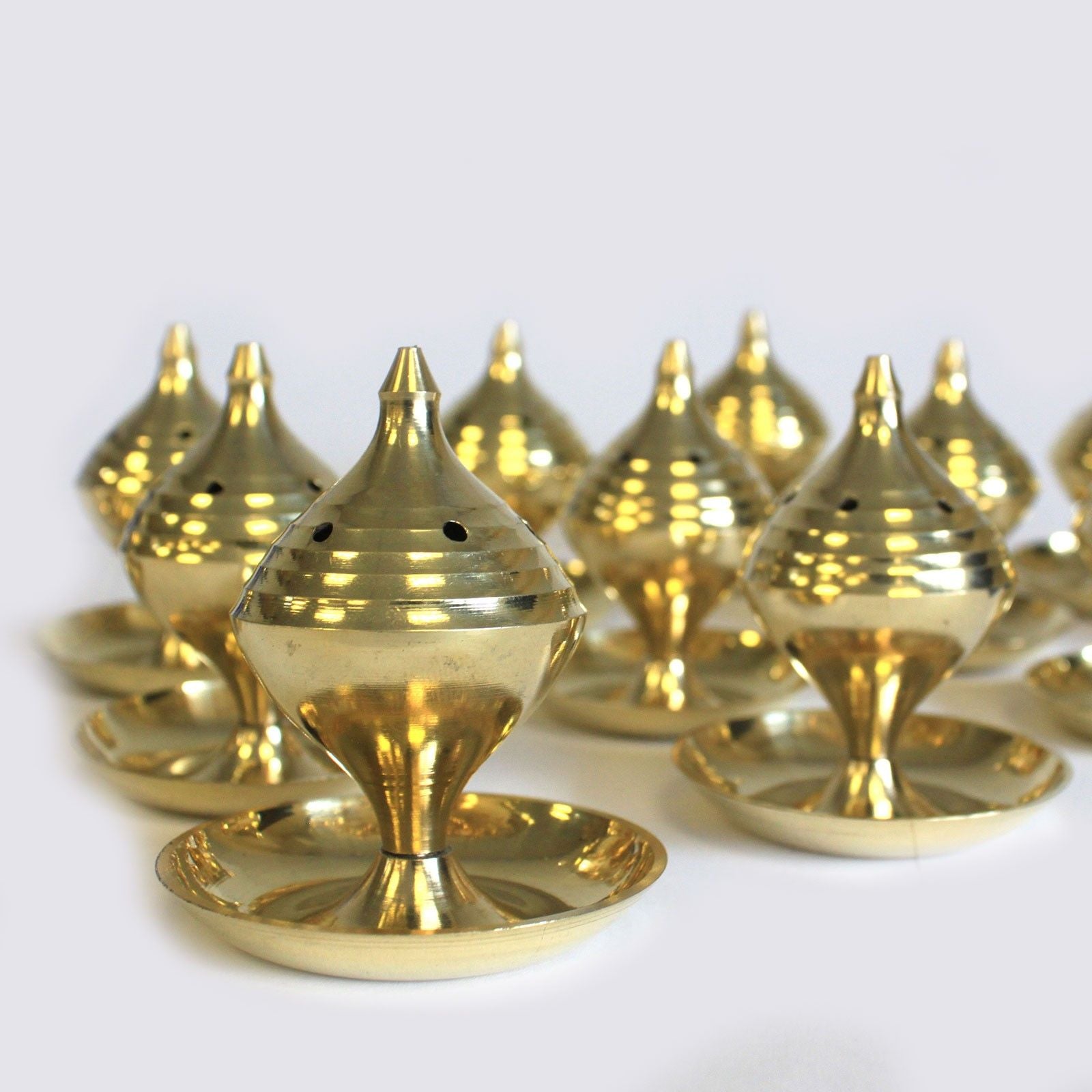 Elegant Medium Brass Incense Burner – Rituals & Meditation displayed among multiple burners, showcasing their unique design and polished brass finish. A charming option for Christmas Gift Home Fragrance.