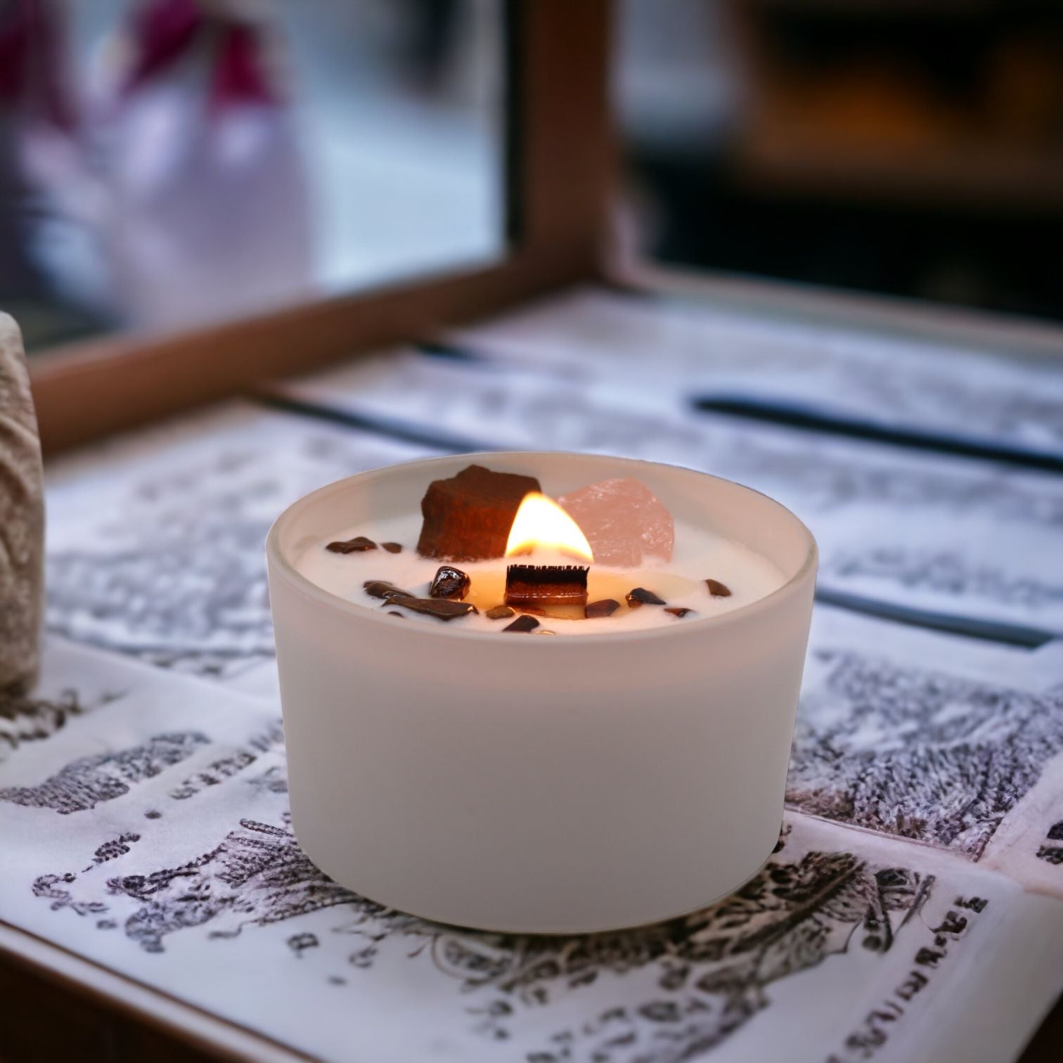 A glowing Sacral Chakra Candle with Tiger Eye and Rose Quartz igniting creativity, placed on a decorative surface. This candle features a soothing fragrance and is perfect as a Christmas gift home fragrance.