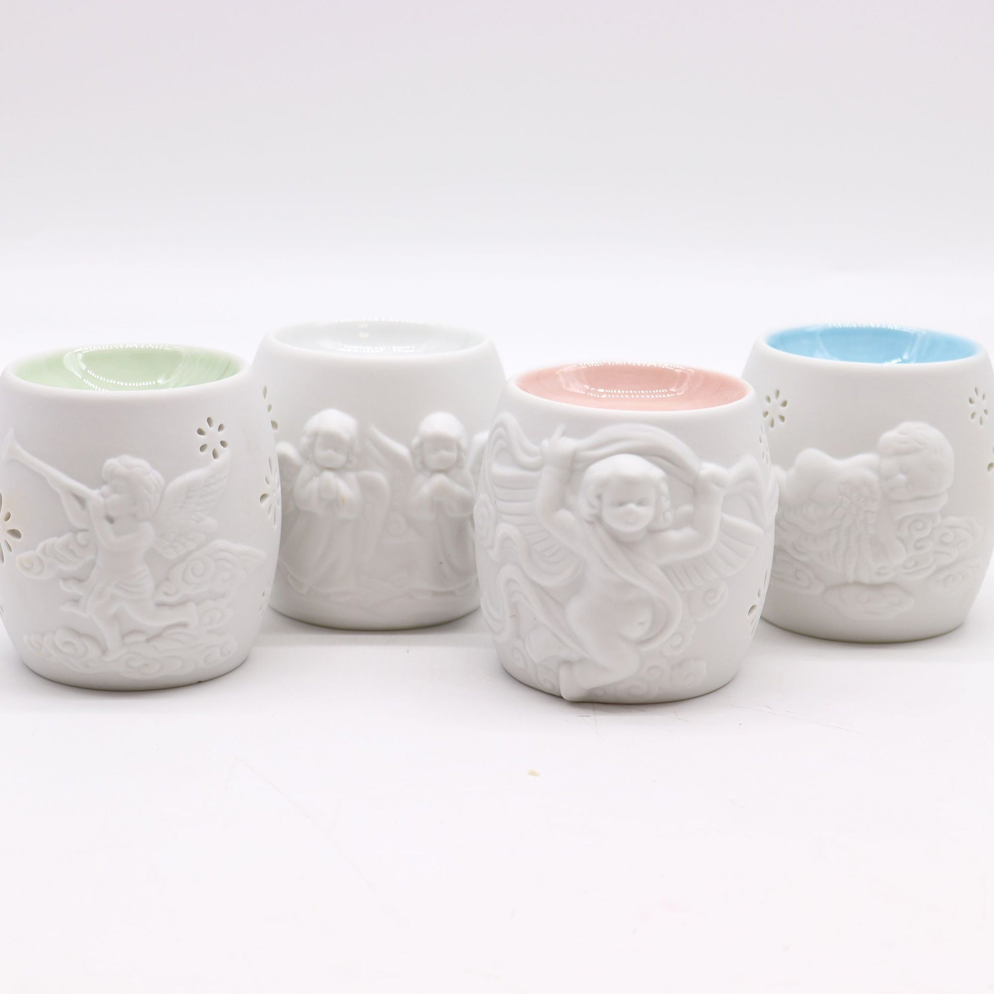 Elegant Cherubs Design Ceramic Oil Burners displaying four assorted styles with intricate cherub designs. Perfect for enhancing your living space and making a thoughtful Christmas gift for those who love home fragrances.
