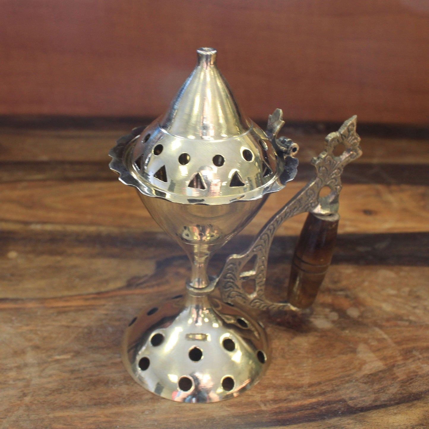 Close-up of an Elegant Brass Cone Incense Burner With Wooden Handle, highlighting its intricate design and polished finish. A beautiful choice for rituals, combining style with functionality, serving as a {{scent}} {{product_type}} – Christmas Gift Home Fragrance.