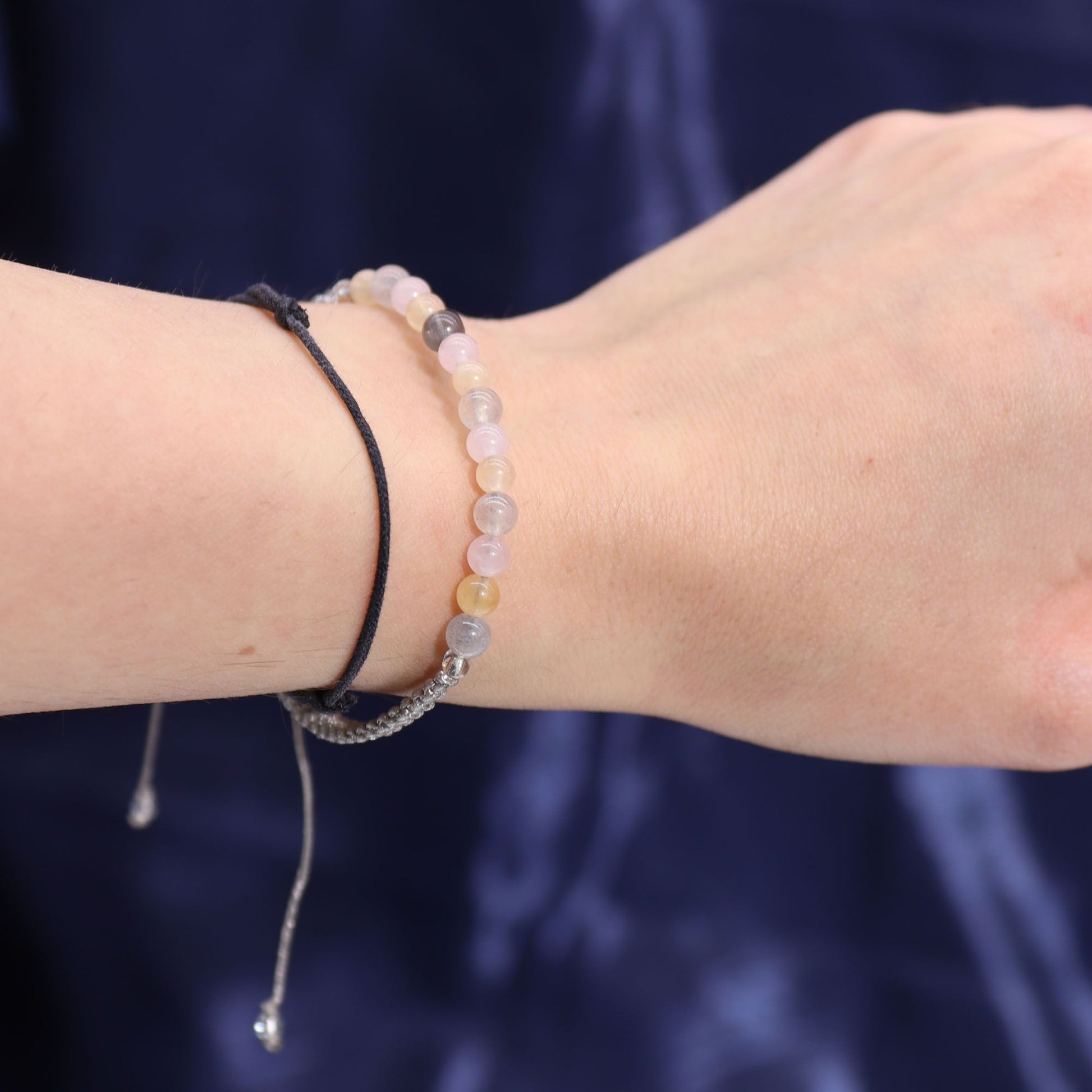 Close-up of the wrist wearing the gemstone bracelet from the Zodiac Crystal Candle with Gemstone Bracelet - Gemini, complemented by the fragrance of Oriental Tiger's Eye for a perfect Christmas gift home fragrance.