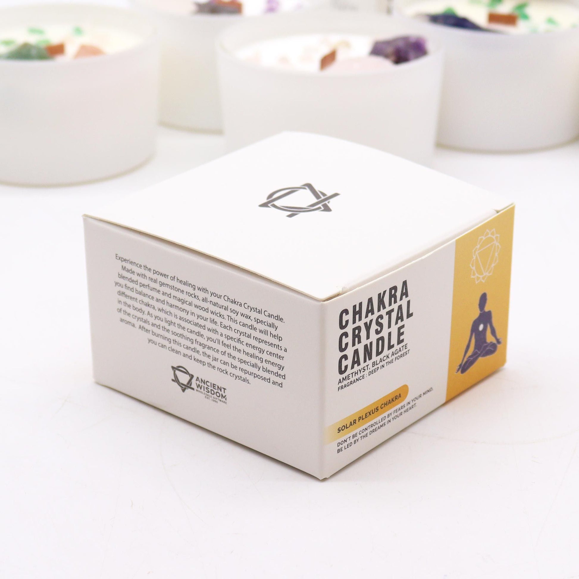 The packaging of the Solar Plexus Chakra Candle highlighting its ingredients and essence. Infused with Amethyst and Black Agate, this candle offers a delightful aroma and is a perfect Christmas gift for enhancing home fragrance.