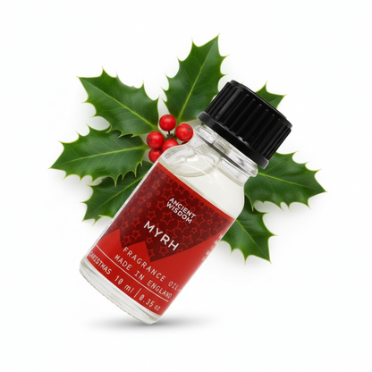 Pouring Xmas Myrrh Fragrance Oil into a diffuser, demonstrating its use as a long lasting fragrance oil for a warm holiday ambience.