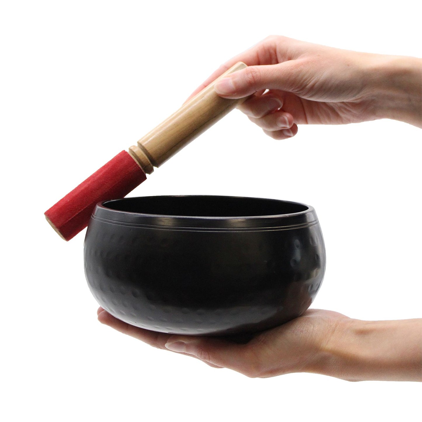 Large Black Singing Bowl - 18Cm for Meditation and Relaxation, shown in use with a hand gently striking it with a mallet, ideal for deep relaxation sessions. {{scent}} {{product_type}} – Christmas Gift Home Fragrance.