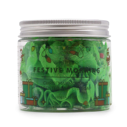 Festive Morning Whipped Soap 120g – Christmas Gift for Cosy Homes features a jar of vibrant green fluffy whipped soap adorned with charming holiday designs. This delightful product, with its soothing scent, serves as a perfect {{scent}} {{product_type}} – Christmas Gift Home Fragrance that brings festive cheer to your bathing experience.