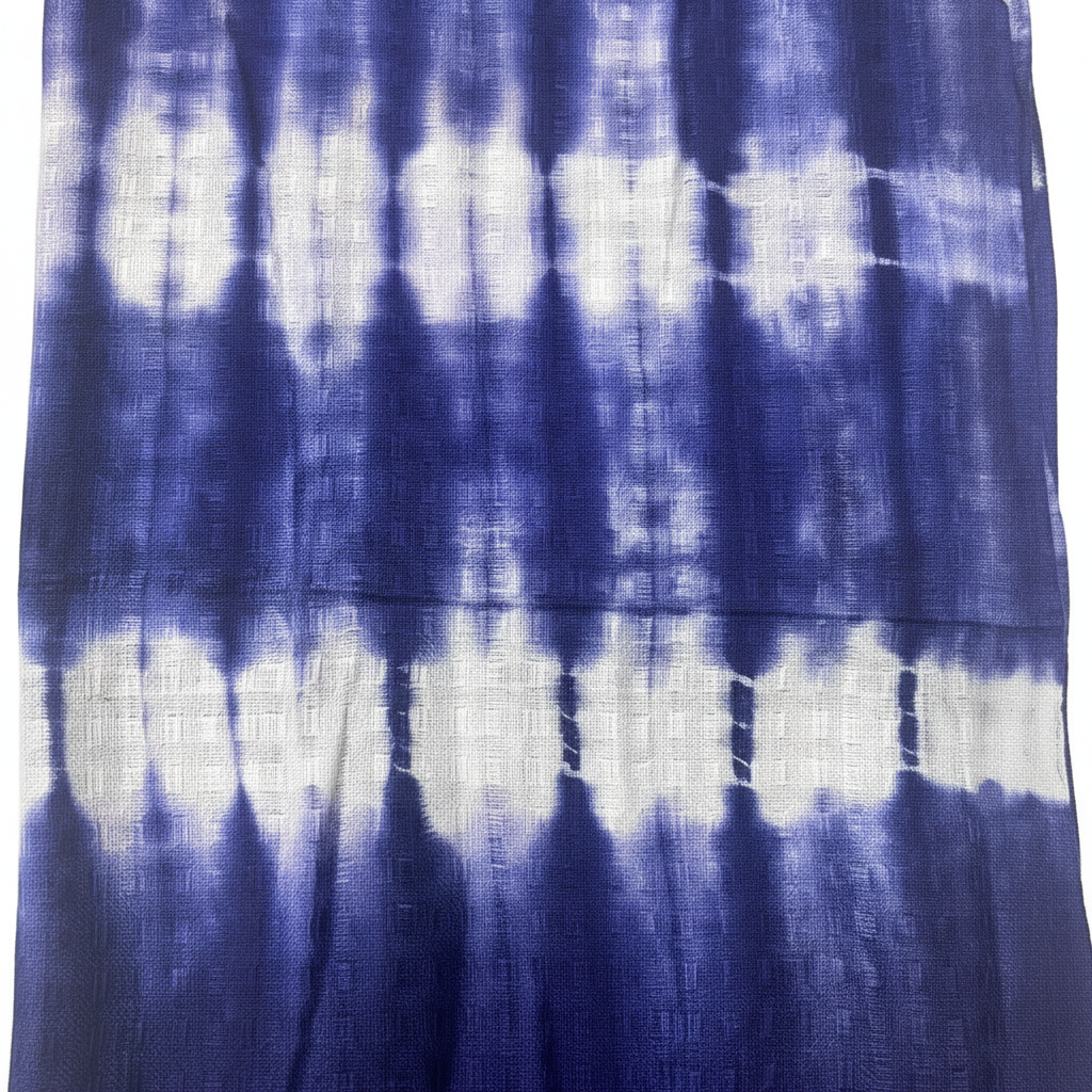 Flat lay of the Boho Indigo Striped Art Stole/Scarf on a textured background, showcasing its unique design and vibrant colors, a must-have boho indigo scarf.