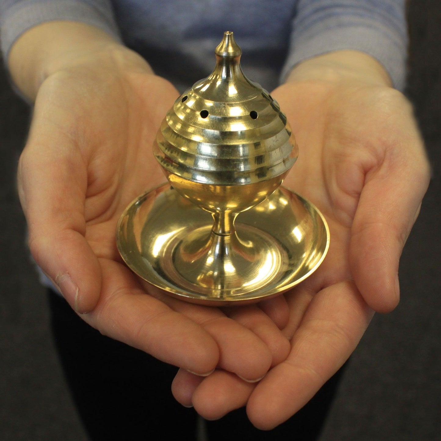 Person holding the Handcrafted Brass Incense Burner for Sticks and Cones, showcasing its compact design and craftsmanship, a thoughtful Christmas Gift for Home Fragrance.