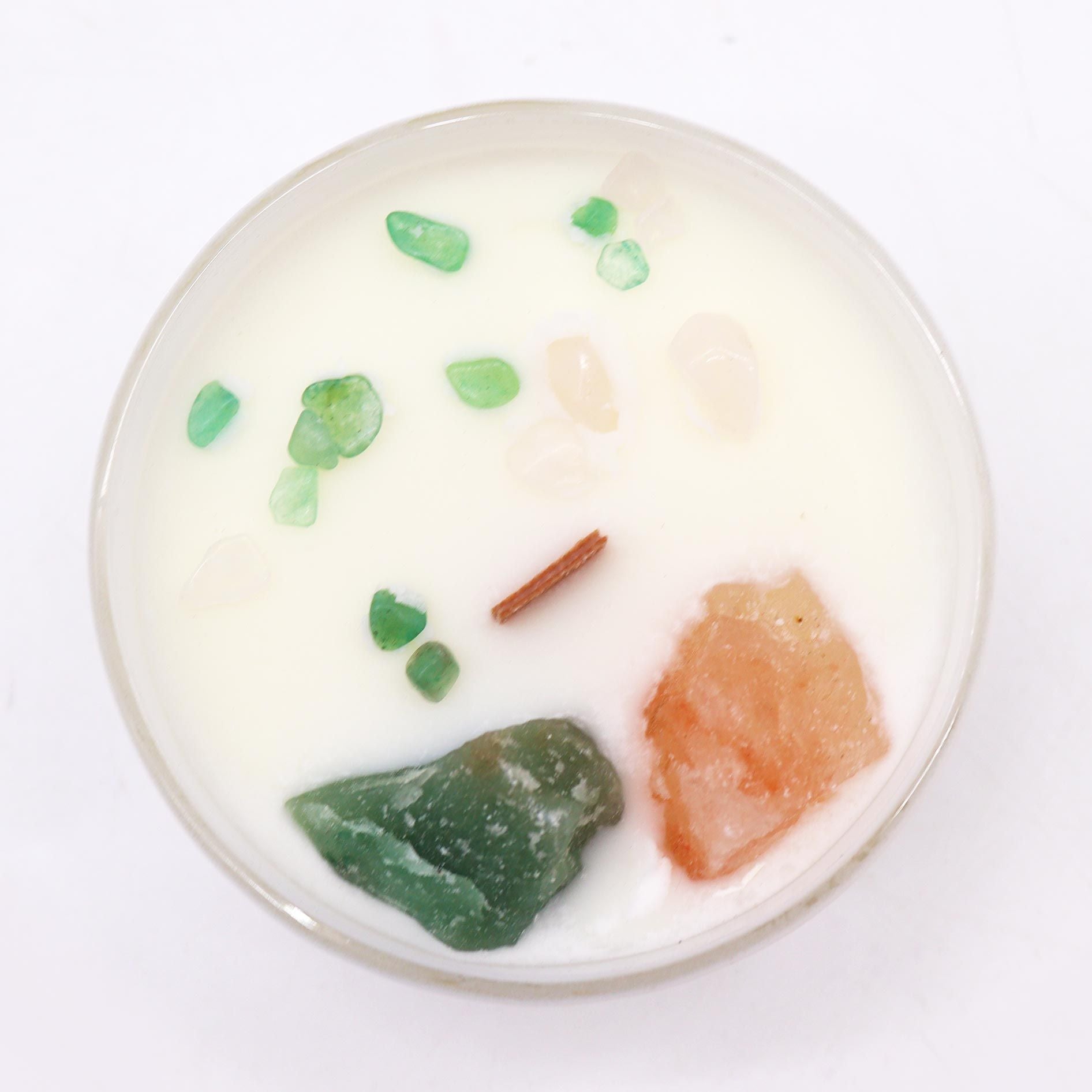 Close-up view of the Heart Chakra Rose Musk Candle, displaying the beautiful blend of crystals like Rose Quartz and Crystal Jade, promoting love and harmony. A wonderful choice for Christmas gift home fragrance.
