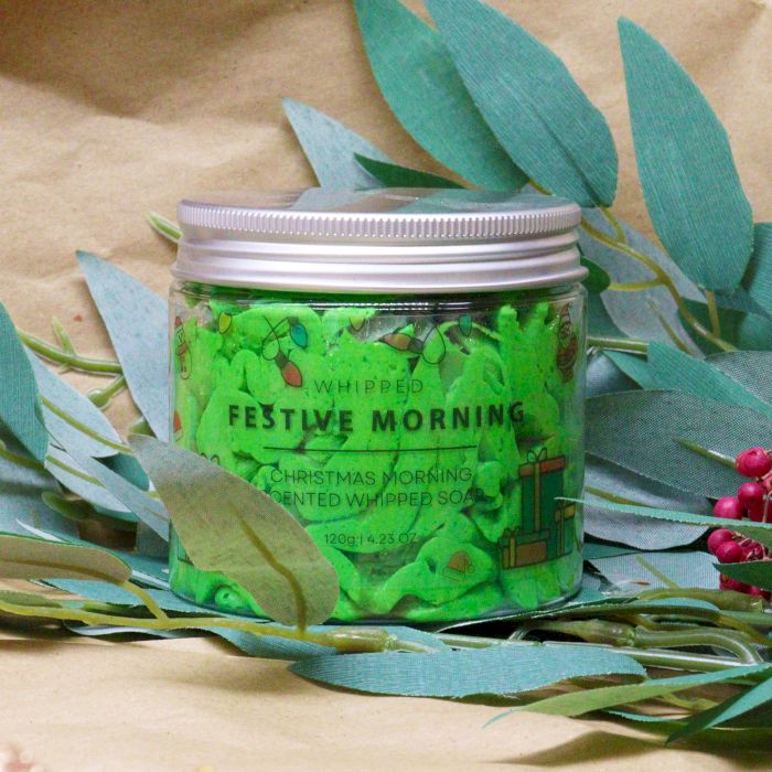 Festive Morning Whipped Soap 120g surrounded by decorative foliage, featuring a cute design and vibrant green colour, making a delightful Christmas gift – Christmas Gift Home Fragrance.