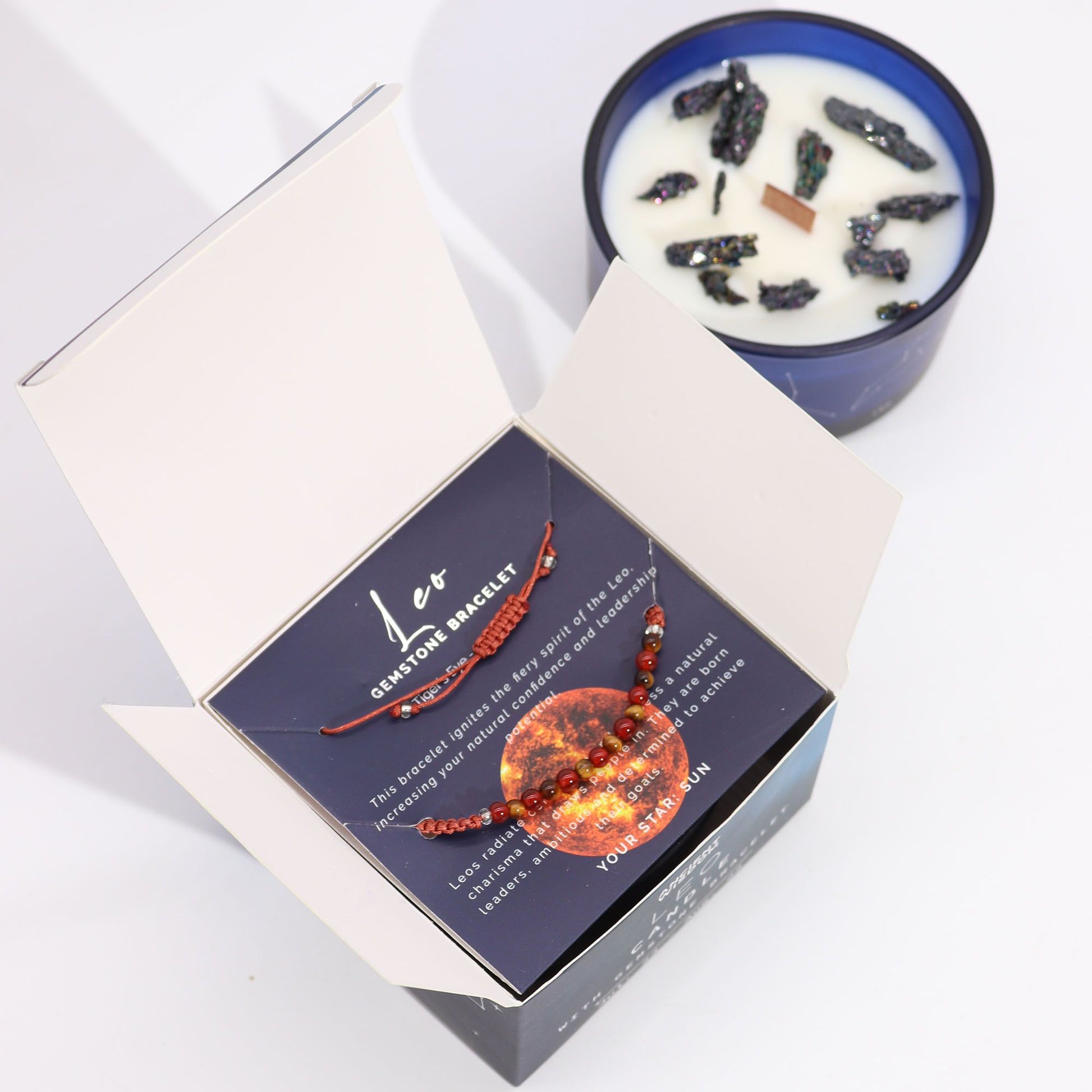 Inside view of the Zodiac Crystal Candle with Gemstone Bracelet - Leo showing the bracelet nestled in a striking blue box next to the fragrant candle. Ideal for a unique Christmas Gift Home Fragrance experience.