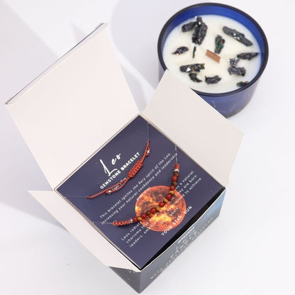 Inside view of the Zodiac Crystal Candle with Gemstone Bracelet - Leo showing the bracelet nestled in a striking blue box next to the fragrant candle. Ideal for a unique Christmas Gift Home Fragrance experience.