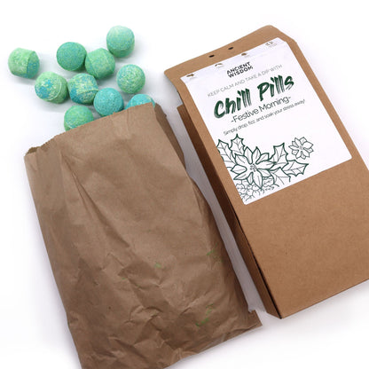 Chill Pills Gift Pack 350g – Festive Bath Bombs for Cosy Homes showing a delightful assortment of turquoise bath bombs scattered beside the opened eco-friendly packaging. This festive {{scent}} {{product_type}} – Christmas Gift Home Fragrance is ideal for a soothing spa experience during the holiday season.