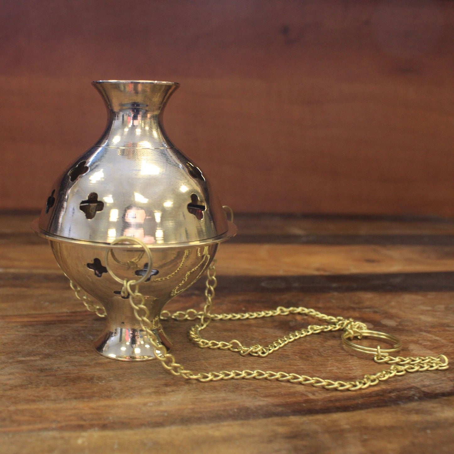 Hanging Brass Incense Burner - Ideal for Meditation & Rituals shown with a focus on its beautiful silhouette and suspended chains. This functional and decorative incense burner is perfect for anyone looking to elevate their home fragrance during the festive season.