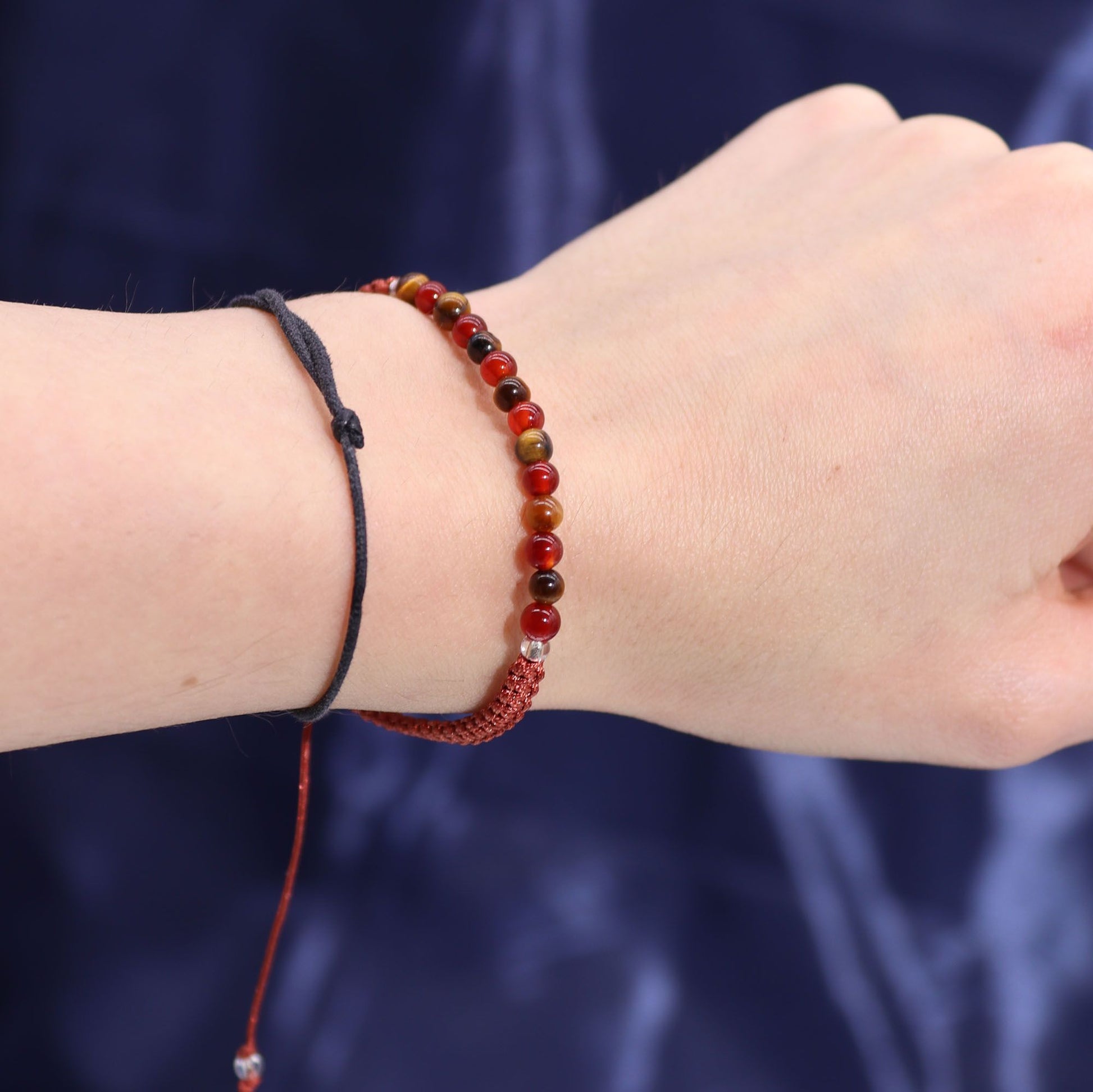 Close-up of the gem-studded bracelet from the Zodiac Crystal Candle with Gemstone Bracelet - Leo on a wrist. Crafted for enhancing confidence and creativity, making it a thoughtful Christmas Gift Home Fragrance.