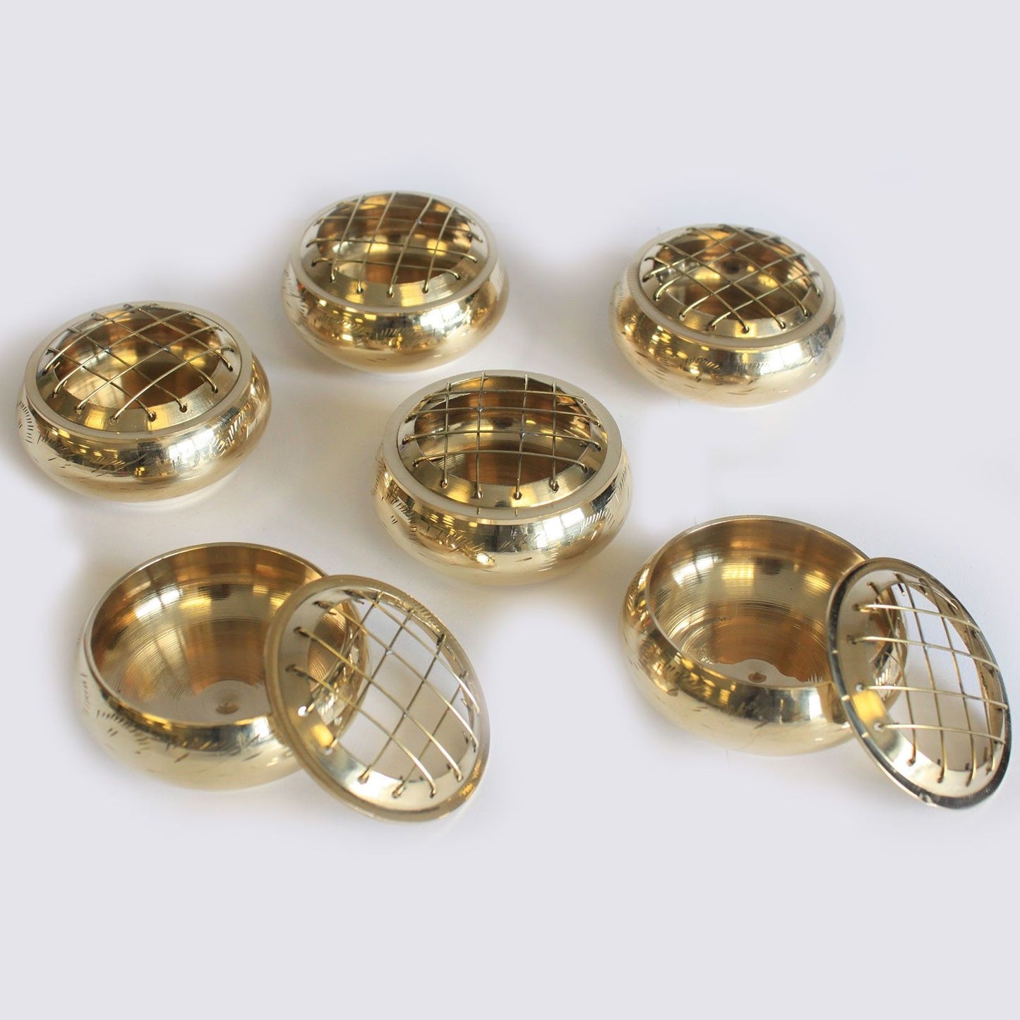 A collection of Elegant Brass Charcoal Incense Jars, featuring their intricate etched designs, showcasing the perfect scent solution for resins and herbs. This {{scent}} {{product_type}} is an ideal Christmas Gift for Home Fragrance lovers.