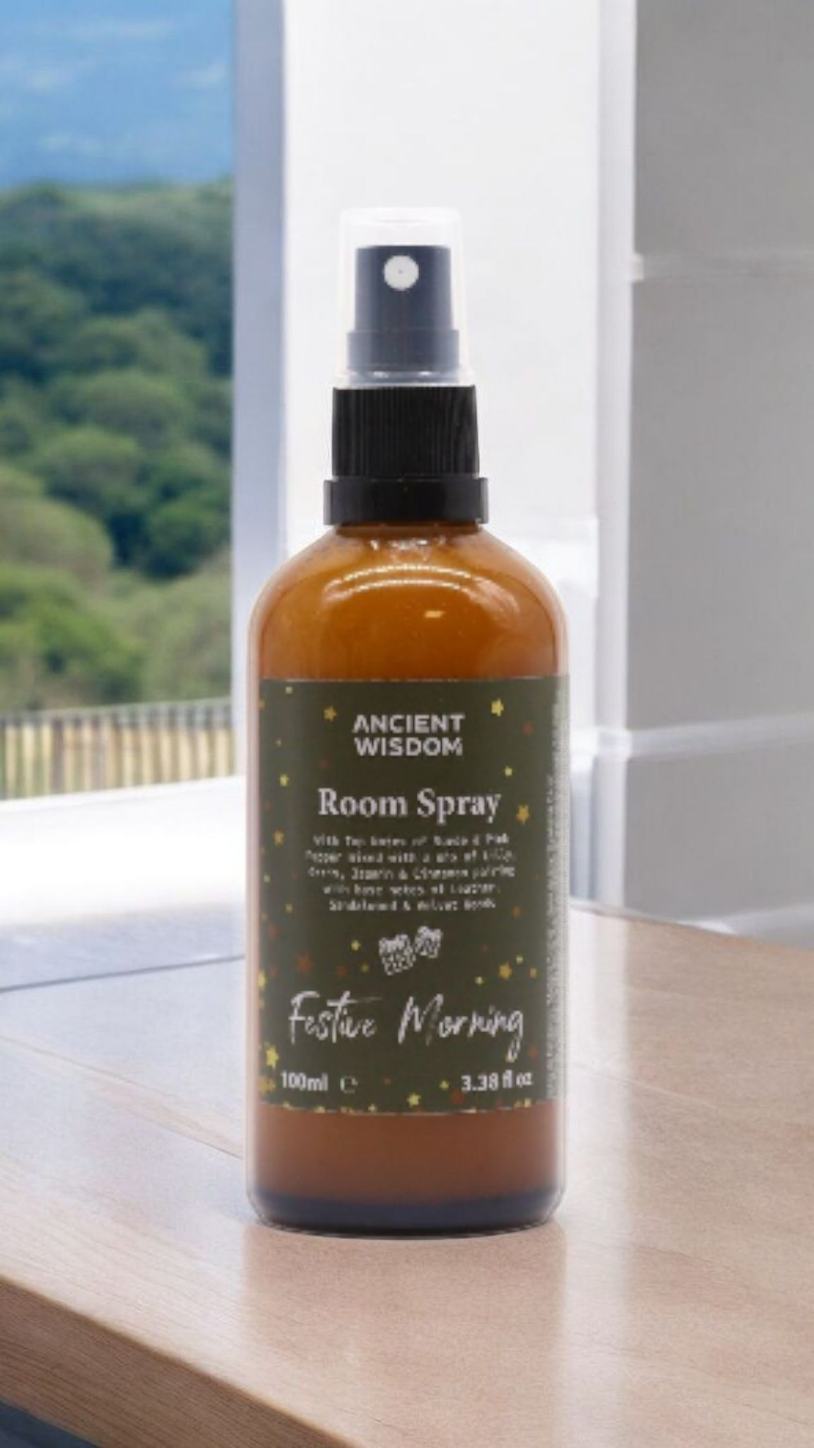 Festive Morning 100ml Christmas Room Spray positioned in a modern setting, ideal for gifting this festive season. This luxurious room spray combines a warm spice aroma, making it a delightful Christmas gift and stocking filler. Infused with winter spice, cinnamon orange, frankincense myrrh, and evoking the ambiance of a white Christmas, it's a must-have for a pamper pack and home fragrance.