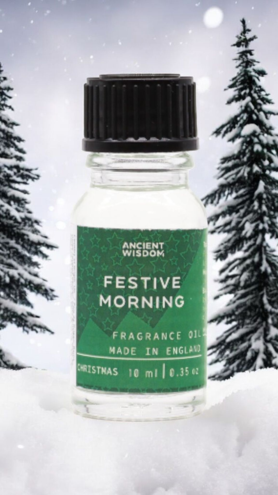 Festive Morning Fragrance Oil 10ml with snow-covered trees, an ideal Christmas gift or stocking filler. This festive fragrance oil brings a touch of winter spice to your home, perfect for aromatherapy or a pamper pack. Enjoy the blend of cinnamon orange and frankincense myrrh to make your festive celebrations truly special.