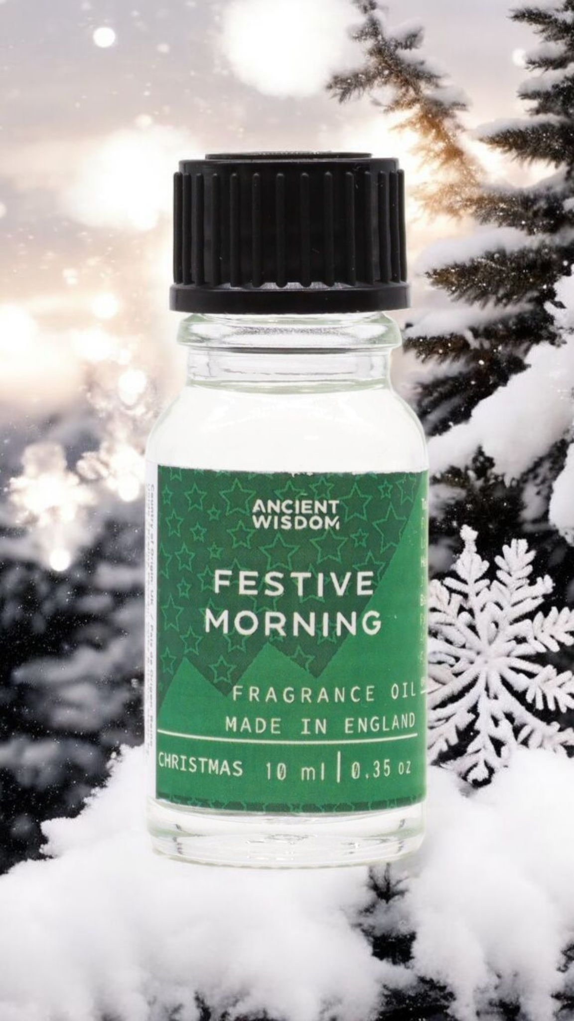 Festive Morning Fragrance Oil 10ml against a snowy backdrop, perfect for Christmas gifts or stocking fillers. This aromatic winter spice scent is a fantastic addition to your home fragrance collection. Ideal for a pamper pack or aromatherapy, it features the enchanting aromas of cinnamon orange and frankincense myrrh, creating a cozy atmosphere reminiscent of a white Christmas.