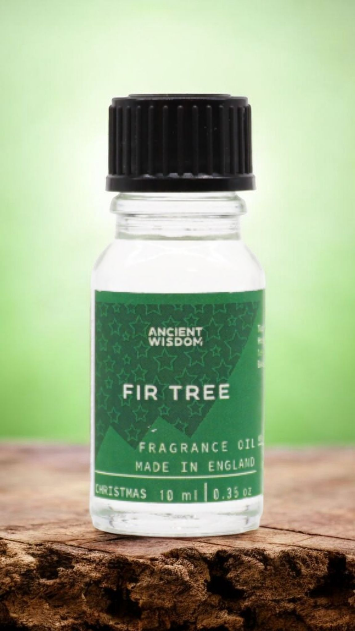 Fir Tree Fragrance Oil 10ml on wooden surface, encapsulating the essence of wilderness, making it a wonderful Christmas gift or stocking filler, perfect for festive fragrance and home fragrance rituals during winter.
