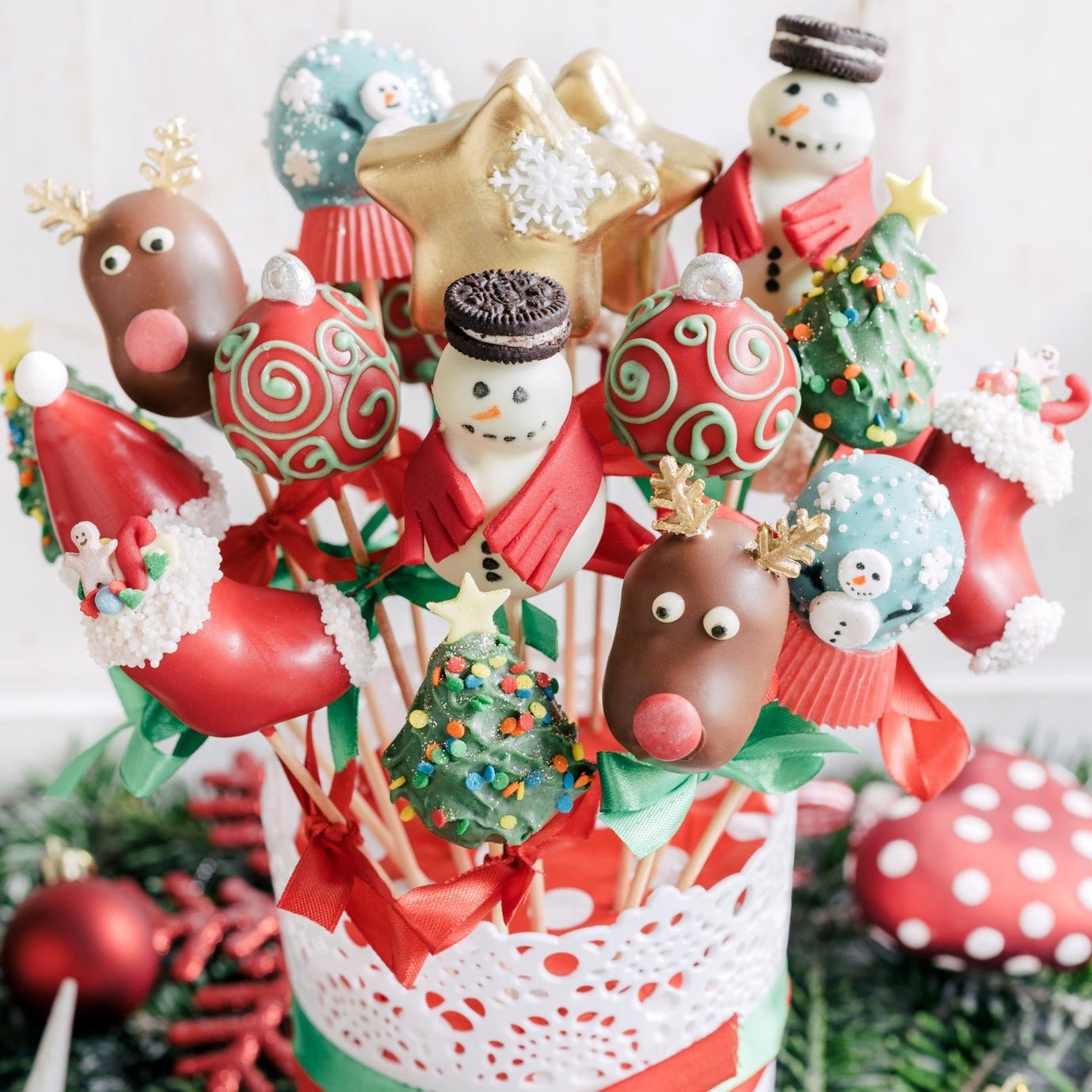 Luxury handcrafted Christmas cake pops bouquet with 15 artisan pops in elegant white lace pot with pink ribbons - premium festive gift