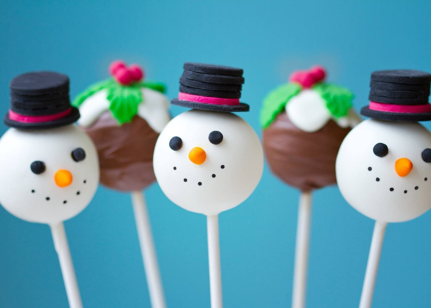 Handmade Christmas snowman cake pops with white chocolate coating and festive decorations